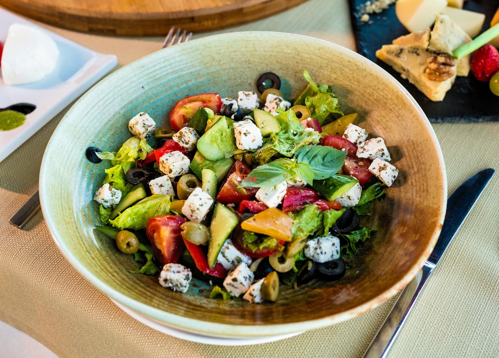 A bowl containing Greek salad.